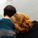 woman resting her head on man