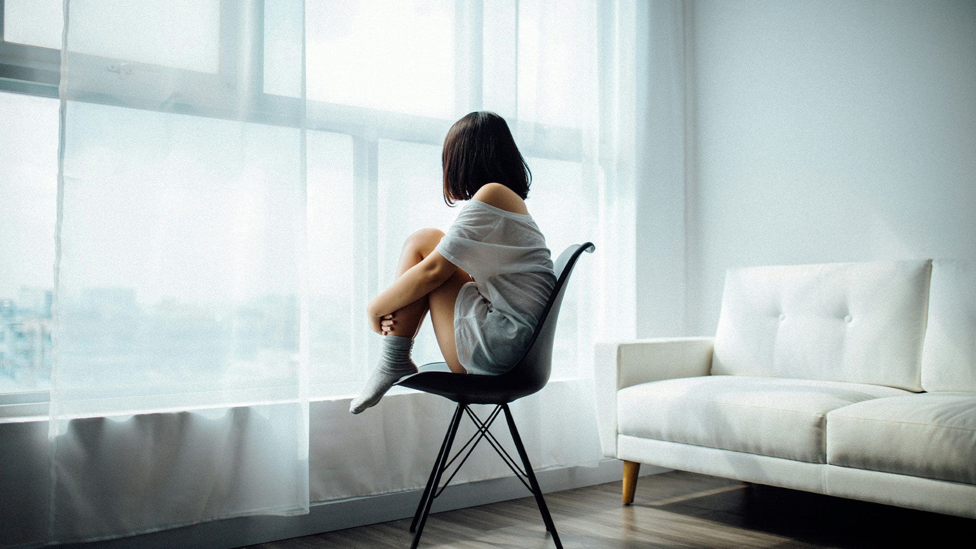 sad woman in front of window